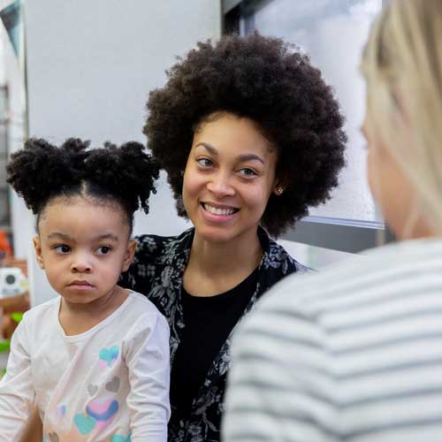 Young african american mother with child, talking to counsellor