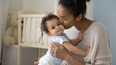 Young mother kissing baby