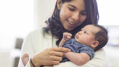 Young mother holding newborn in arms